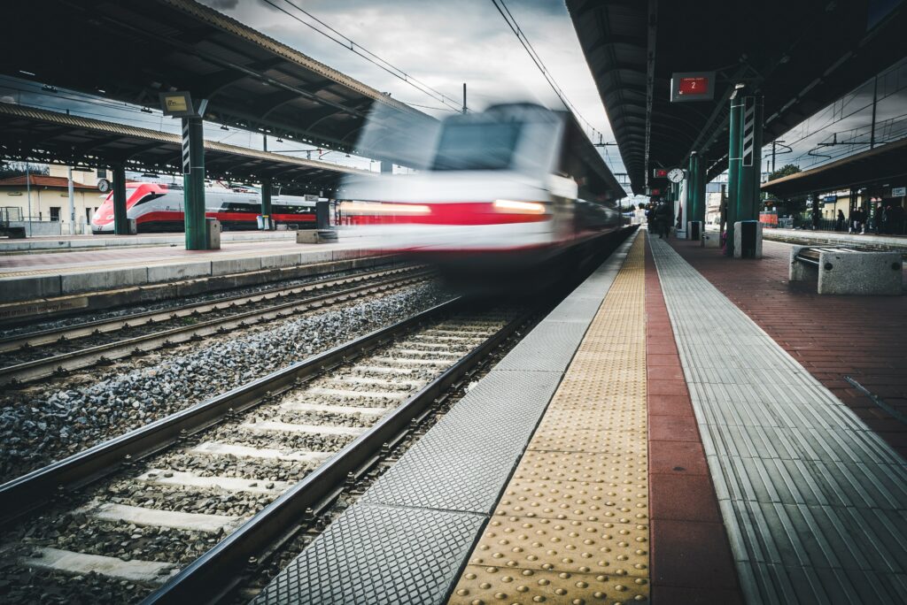 A group of people standing next to a train station photo – Free Italia  Image on Unsplash